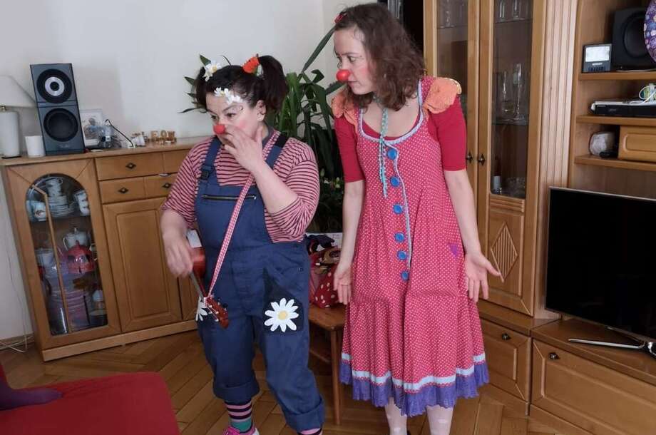 Zwei Clowns stehen in dem Wohnzimmer von einem Jungen der Geburtstag hat 